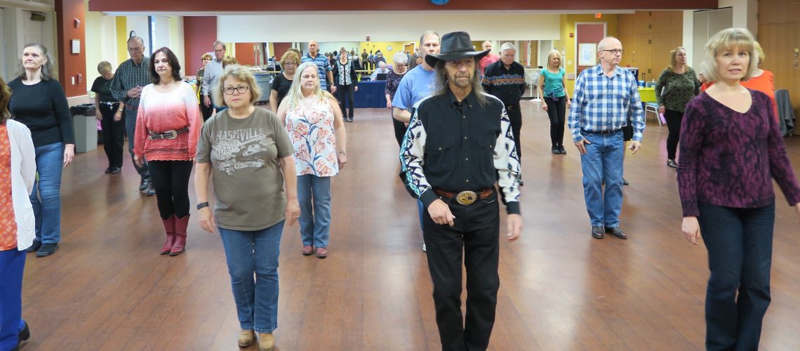 Photo of line dancers with Bernie and Olga at Lincolnia Sr Center